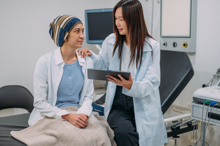 Photo shows a gynecologist talking to her patient about cancer awareness and test results/Getty Images