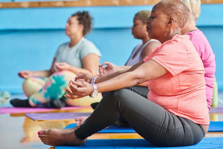 Photo shows a group of women attend ing a yoga class/Getty Images