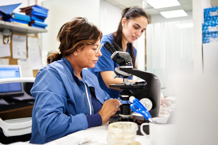 Photo shows two female researchers working in a lab/Getty Images