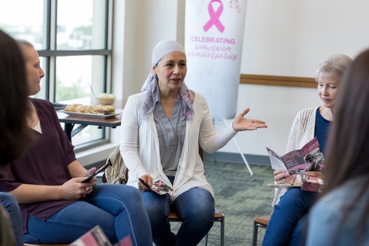 Photo shows several women attending a breast cancer support group/Getty Images