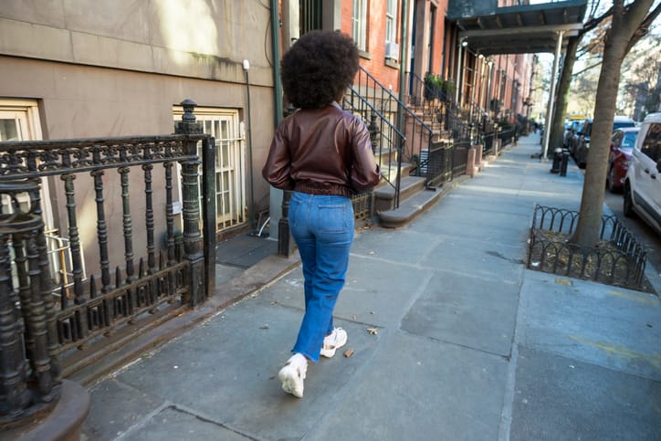 Photo shows a woman walking down the street in New York City/Getty Images