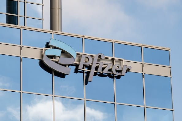 Photo shows the Pfizer logo on a glass office building with sky reflections, South San Francisco, California, October 16, 2025. (Photo by Smith Collection/Gado/Getty Images)