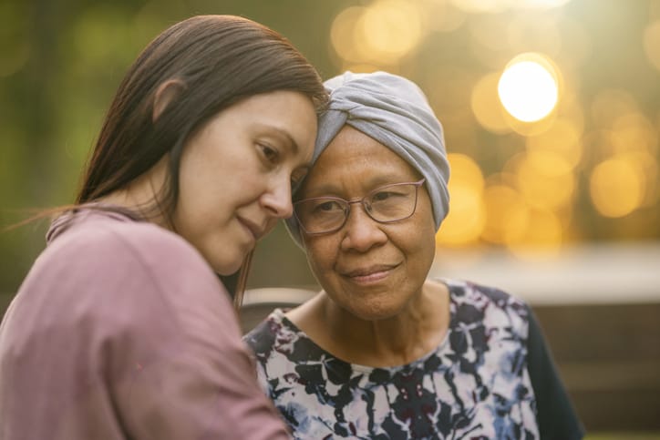 Photo shows a daughter comforting her mother/Getty Images