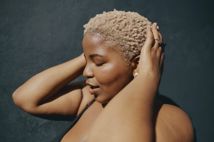 Photo shows a woman touching her hair/Getty Images