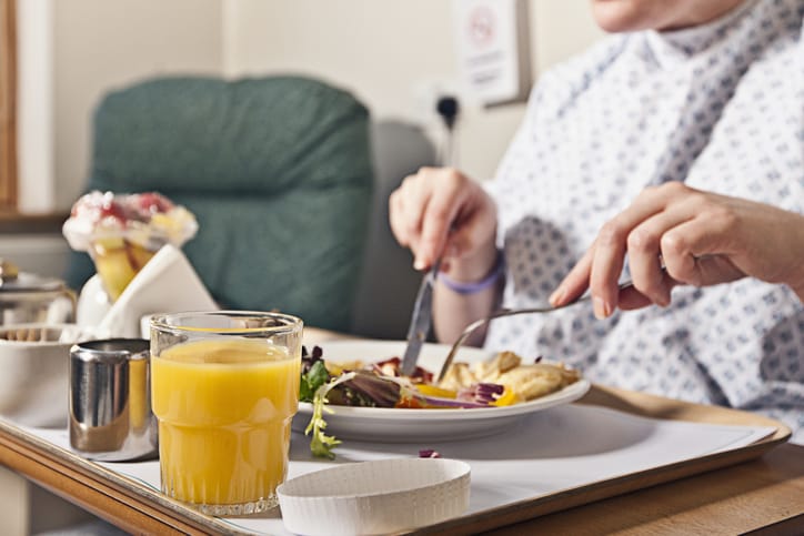 Photo shows a hospital patient eating dinner/Getty Images